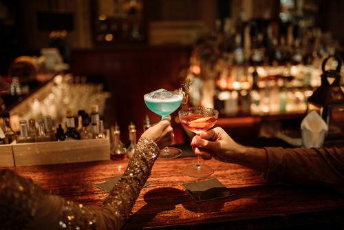 a couple toasting drinks