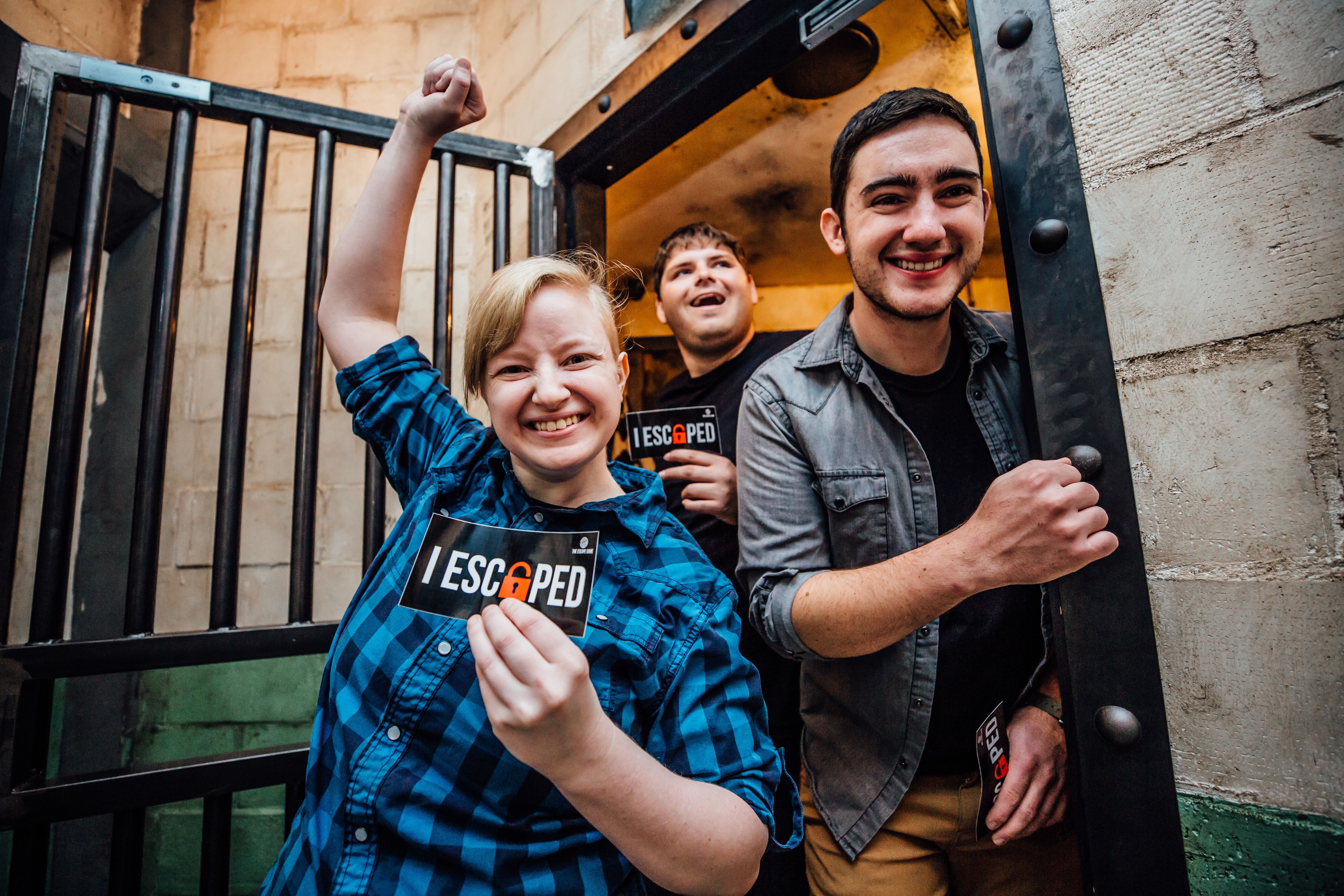 Three happy people winning an escape room