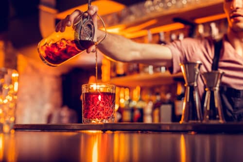 a bartender pouring a drink