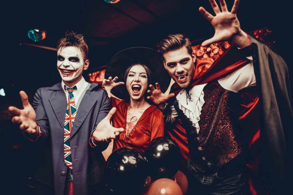 3 adults in halloween costumes