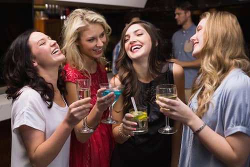 women drinking at a bar