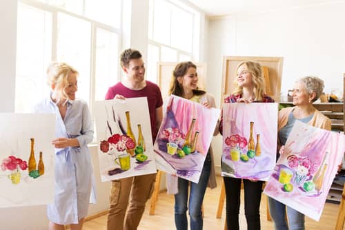 people showing each other their paintings