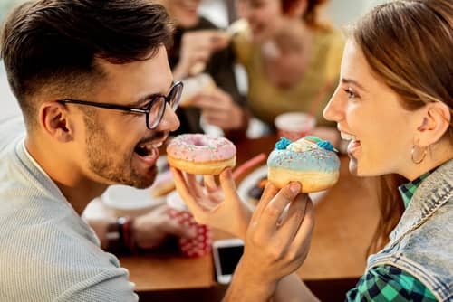 a couple eating donuts