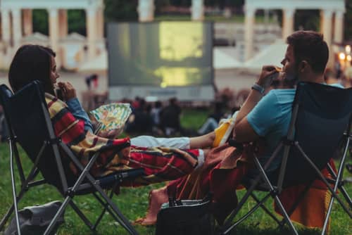 a man and a woman at an outdoor movie