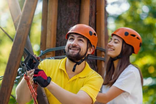 a man and a woman ziplining