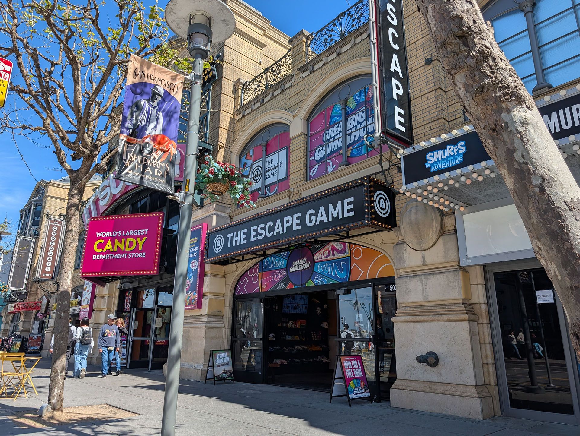 Entrance of "The Escape Game" with colorful signage. Nearby, a banner advertises "World's Largest Candy Department Store."
