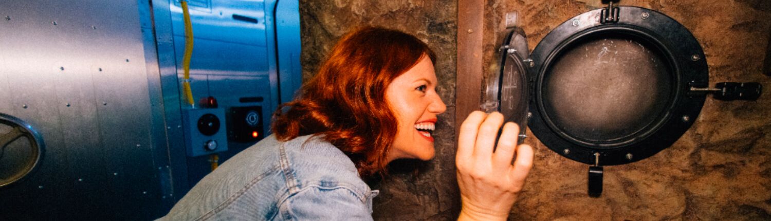 woman playing the depths escape room at the escape game