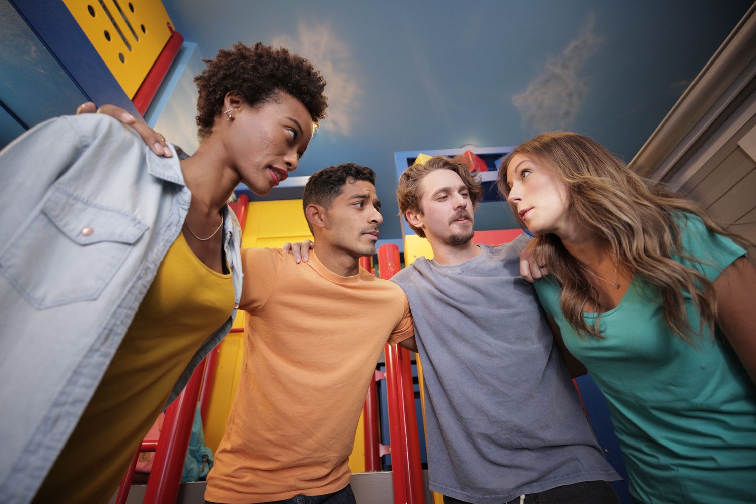 4 people huddled together to solve an escape room