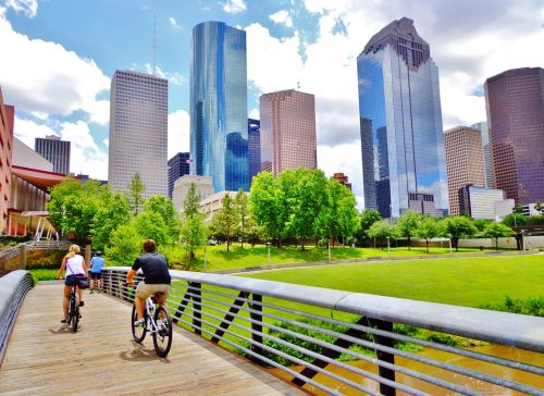 two people biking in an urban park