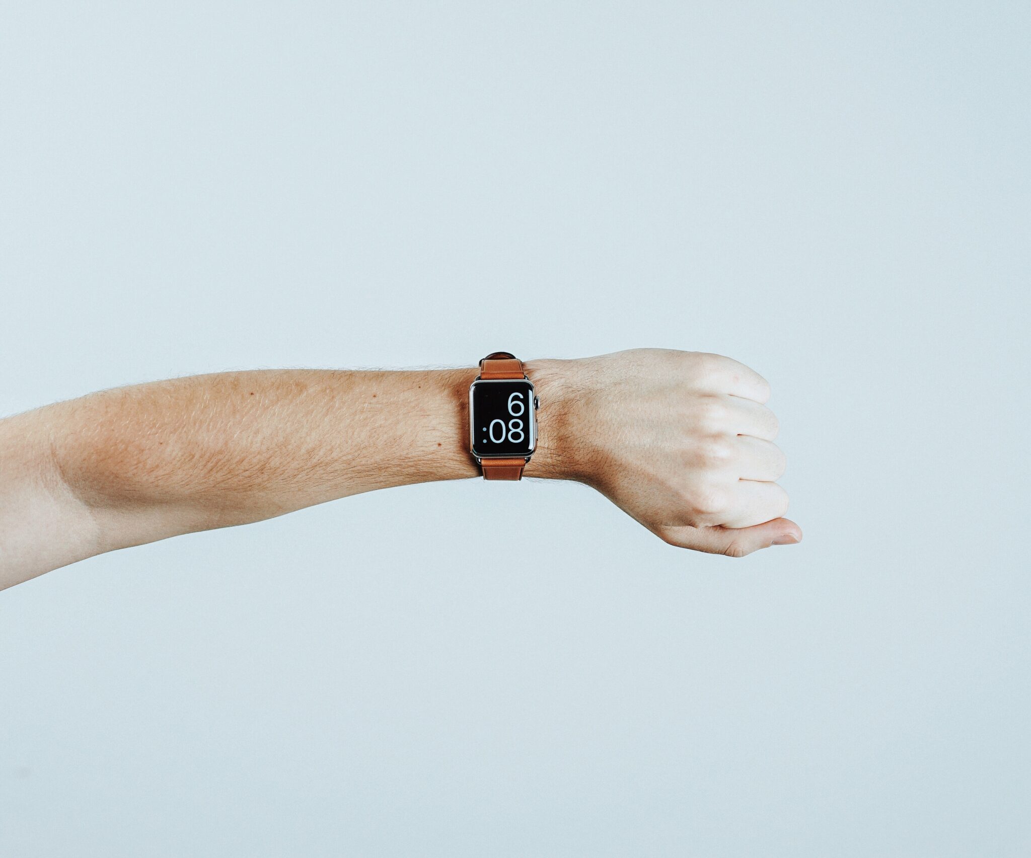 person wearing a watch and showing the time