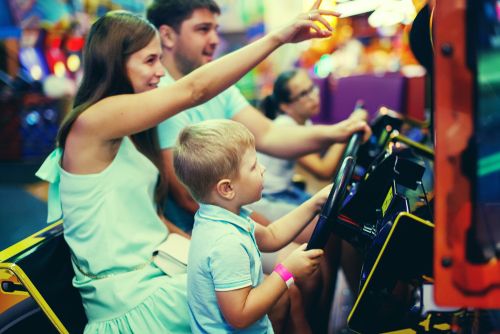 a family playing arcade games
