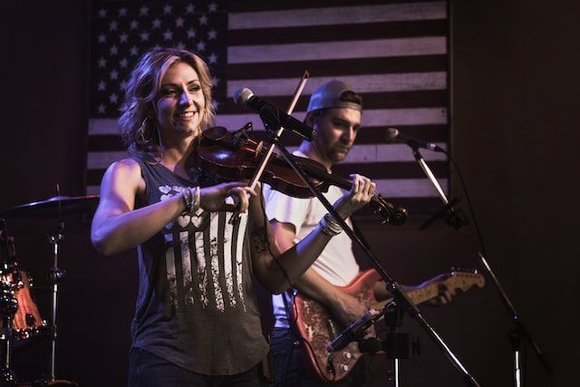 a woman playing a fiddle