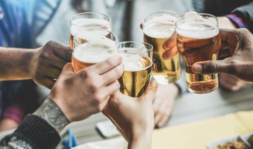 people toasting pints of beer