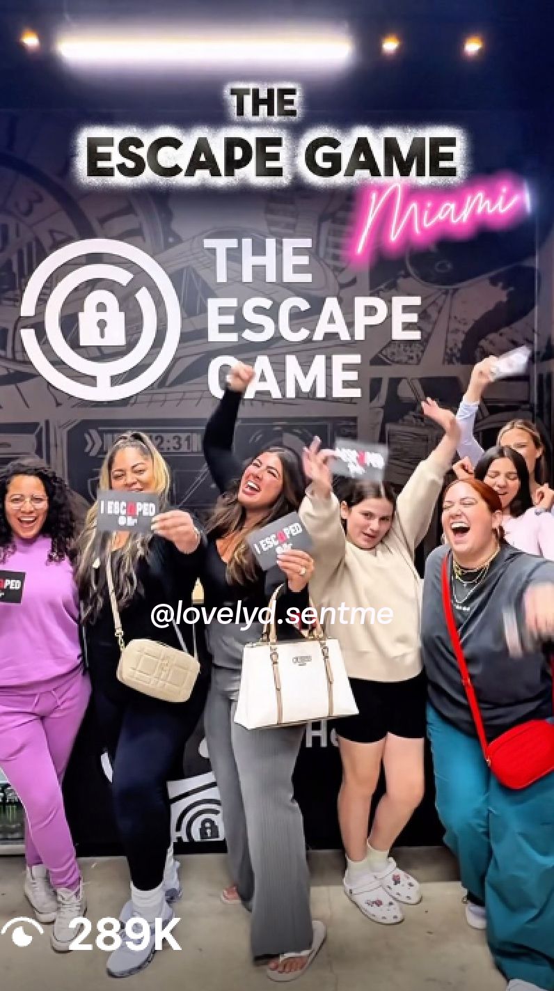 A group of women celebrate outside "The Escape Game Miami," holding signs that say "I ESCAPED" and smiling joyfully.