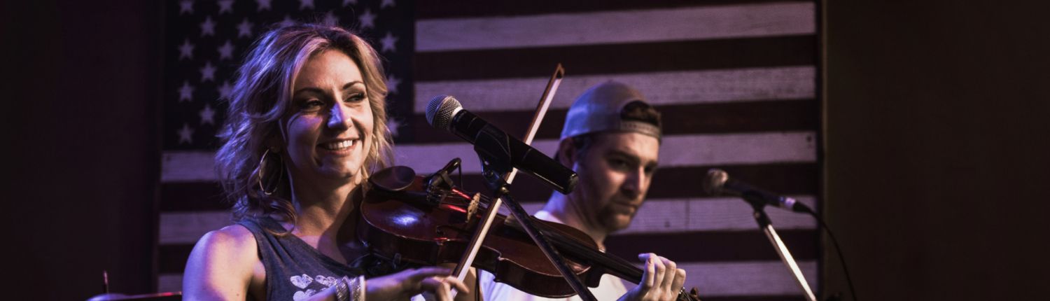 woman playing the fiddle at a concert
