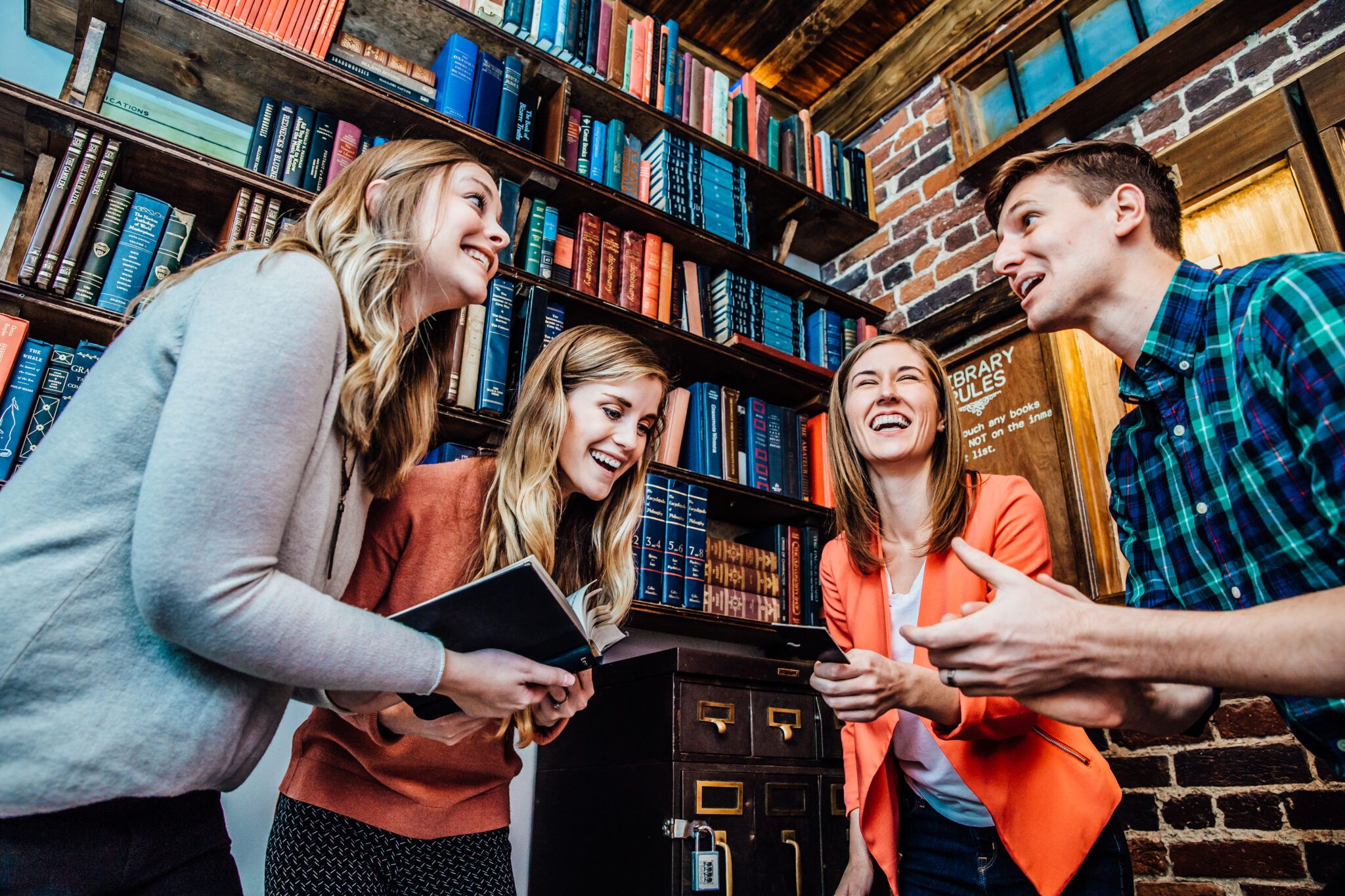 4 people solving clues to escape an escape room